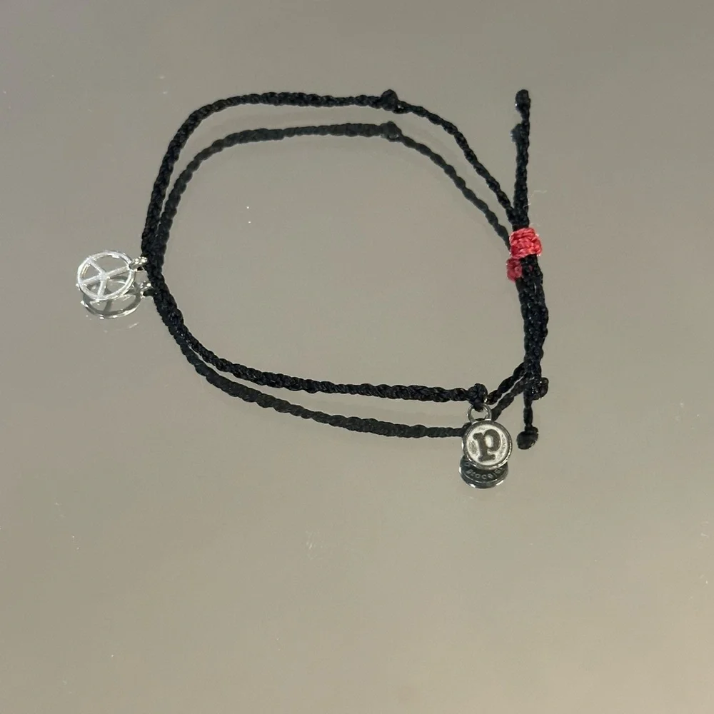 Pura Vida. Black Braided Bracelet with Silver Peace Charm and Red Accent